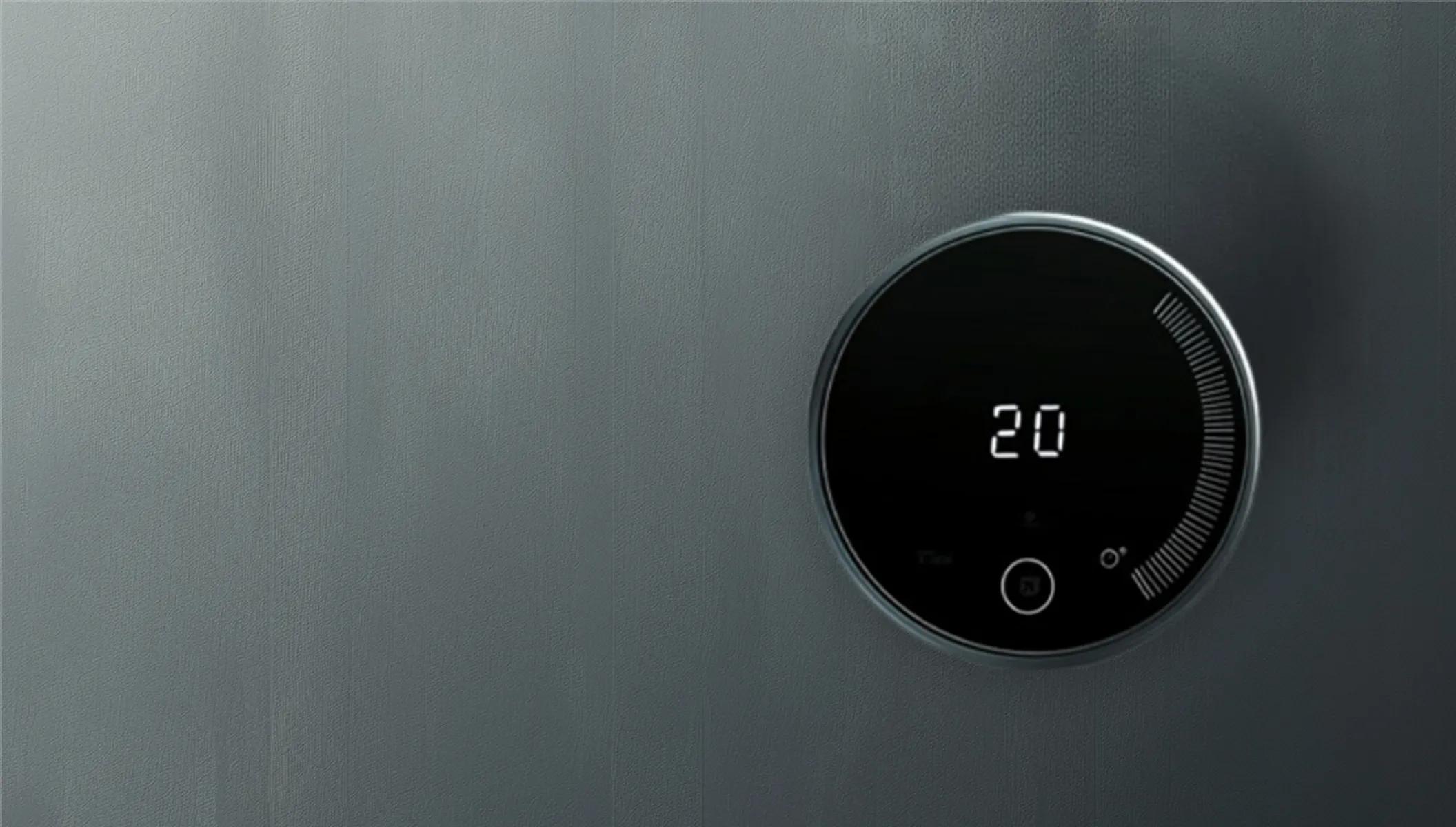 A close-up of a modern, round black smart thermostat digital display mounted on a wall showing a indoor temperature setting of 20 degrees.