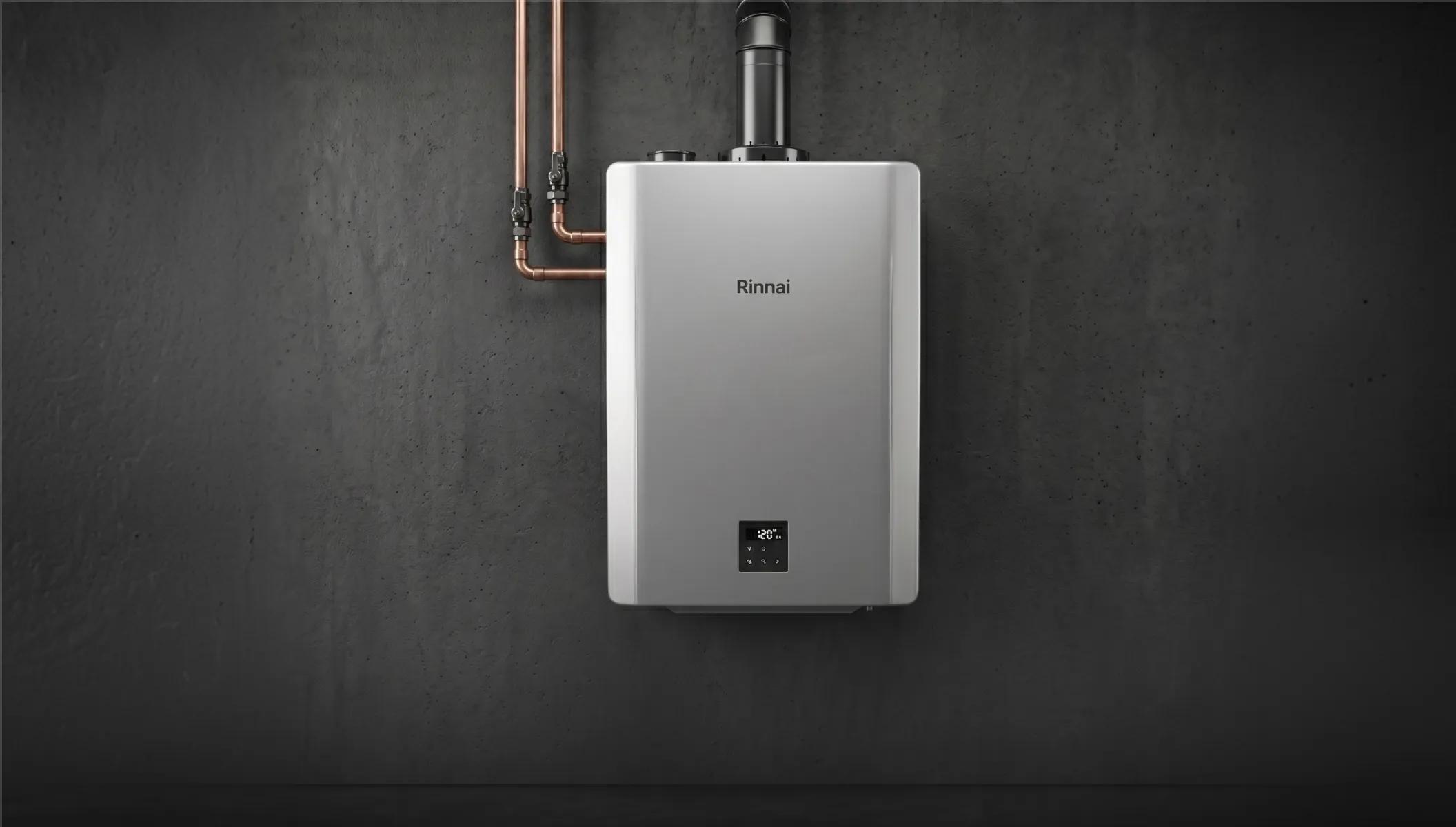 A silver Rinnai wall-mounted tankless water heater unit installed with professional copper piping connections.