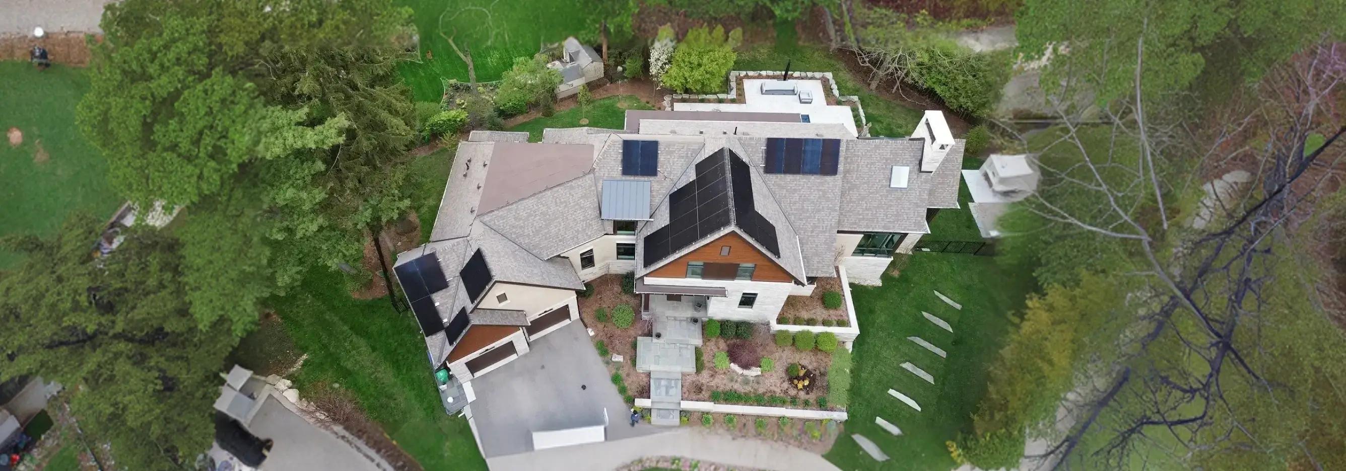 High-efficiency Ontario solar and battery installation featuring a modern suburban home and a large-scale commercial rooftop solar array.