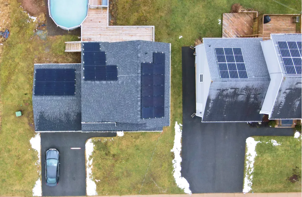 Aerial view of a high-efficiency residential solar panel system installed on a dark shingled roof for a Nova Scotia homeowner.