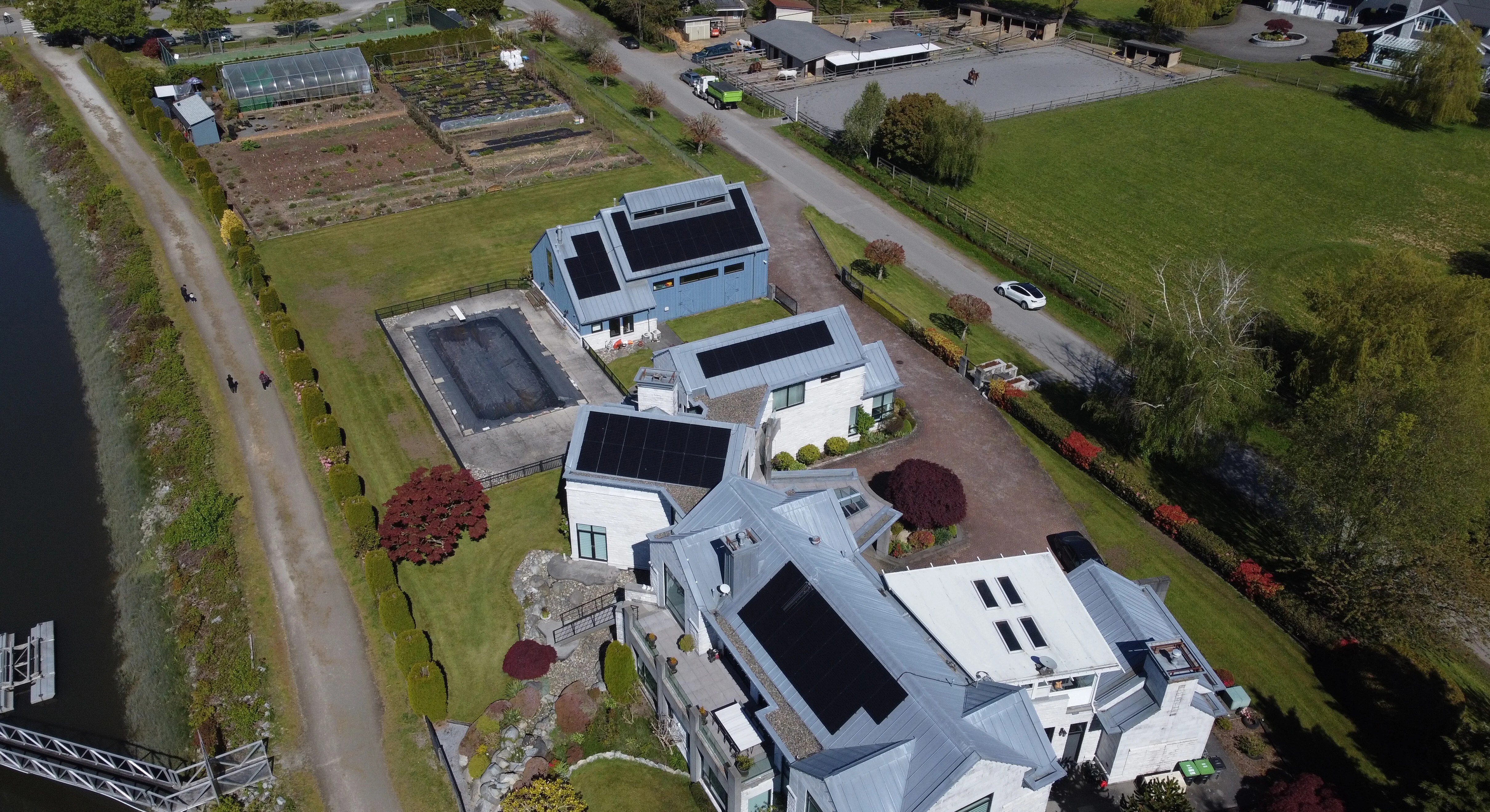 Multiple residential houses have installed solar panels on their roofs.